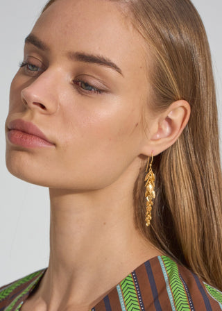 Model wearing MEGAN PARK Gold Leaf Tendril Earrings with delicate cascading gold leaves and fine chain detailing.